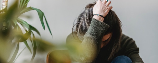 Woman with head in hands