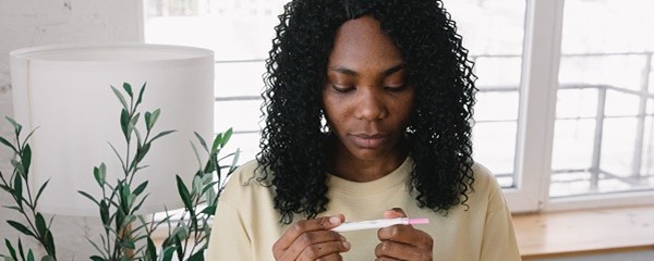 Woman looking at pregnancy test