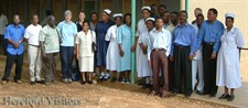 staff from Hereford visit the Muheza Hospital, standing with staff at the hospital for a photograph